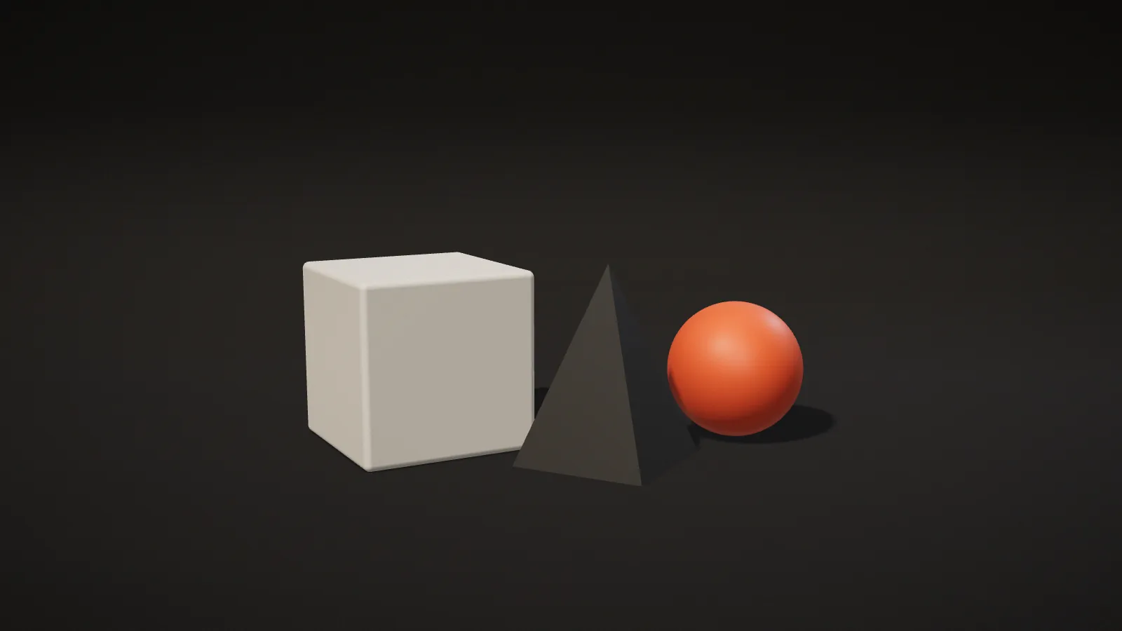 Three matte geometric shapes — a cube, a pyramid and an orange sphere — on a dark studio set, representing the building blocks of graphic design